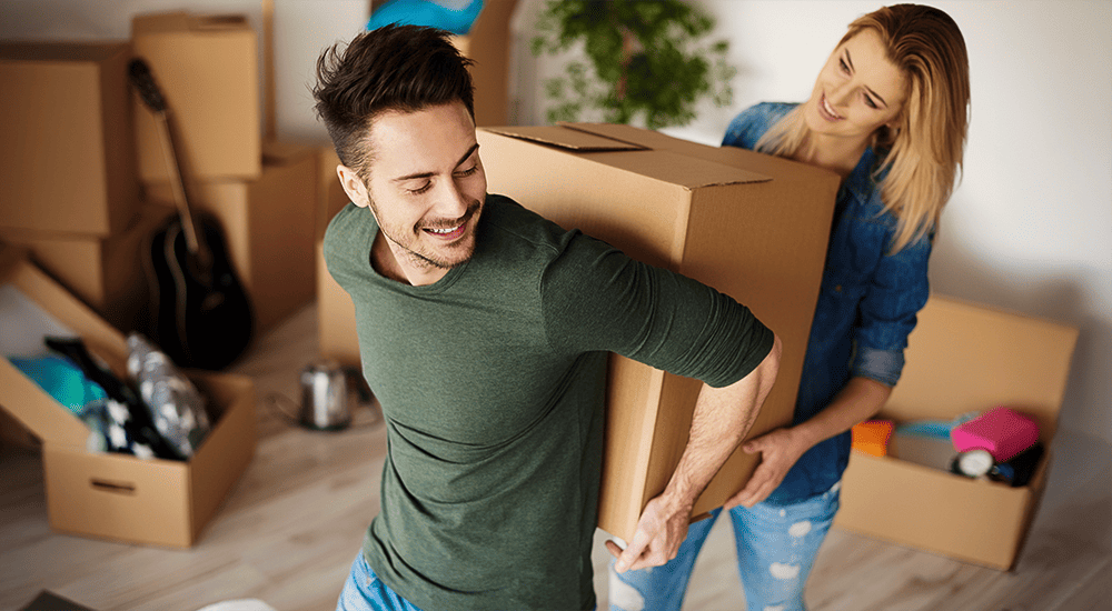 Imagen de una pareja trasladándose a su nuevo departamento o inmueble comprado.
